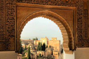 Alhambra Palace Granada view through Islamic arch - Spain tours Heaven Tours